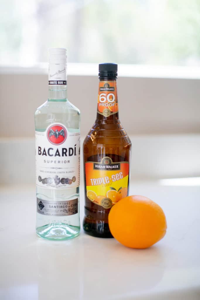 An image of Bacardi rum, orange liqueur, and an orange