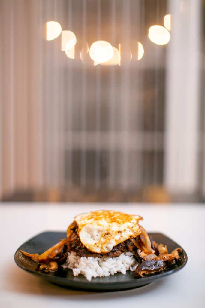 Chopped steak served over rice and topped with a cooked egg