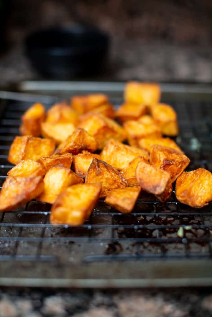 Fried patatas bravas set aside to cool