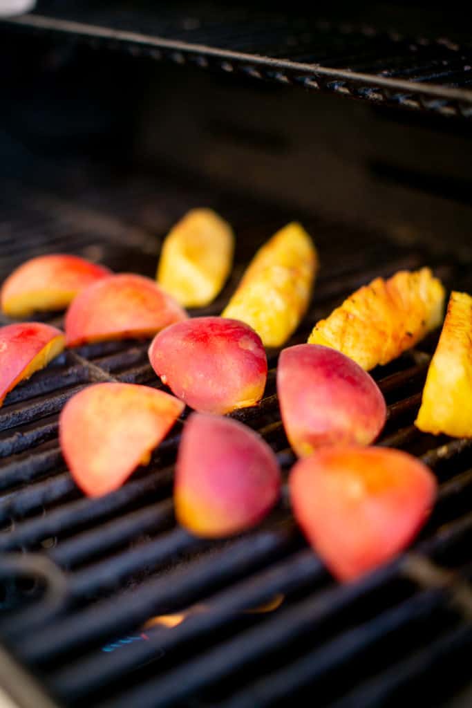 Outdoor grilling peaches and pineapples