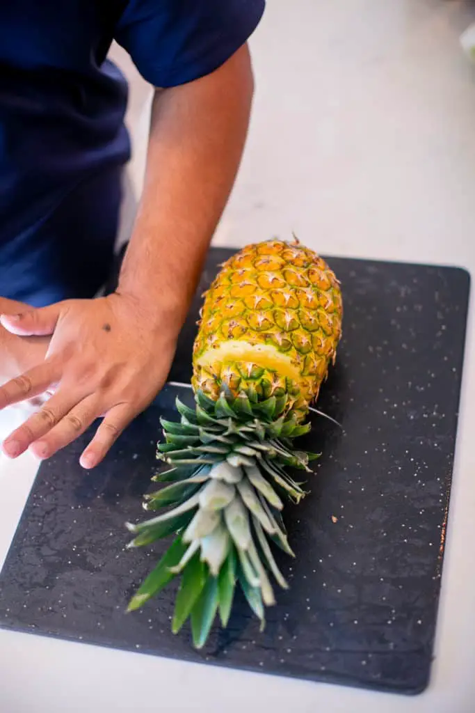 Cutting the pineapple into slices before grilling