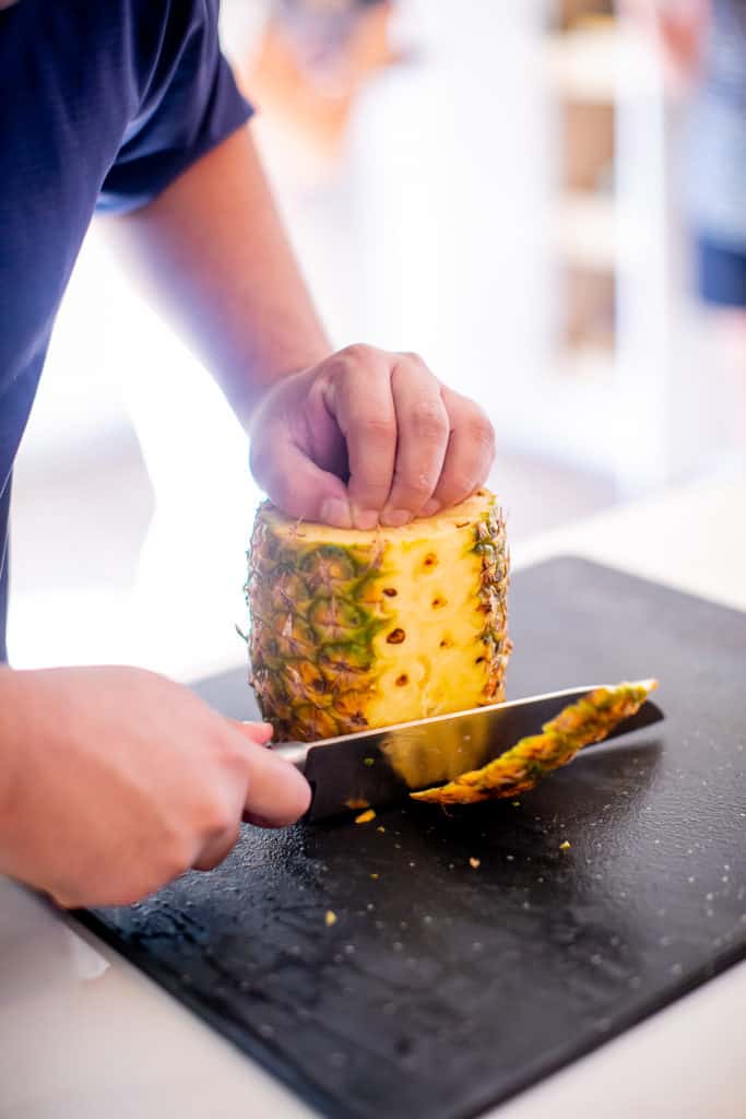 Slicing a pineapple using a chef's knife