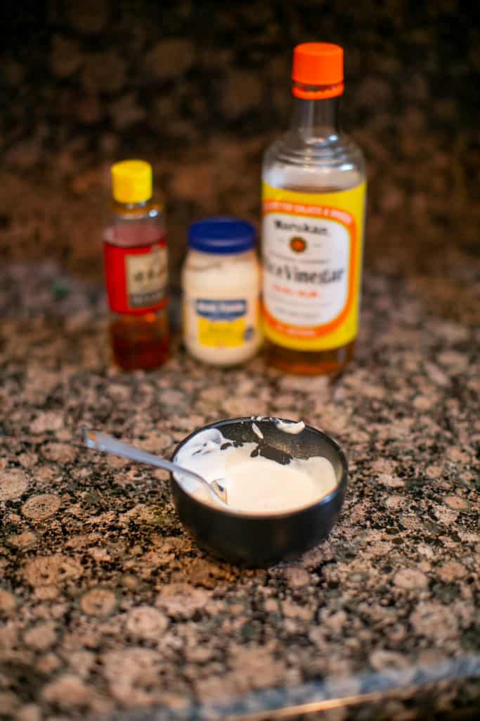 Photo of a japanese white sauce with some of the ingredients in the background