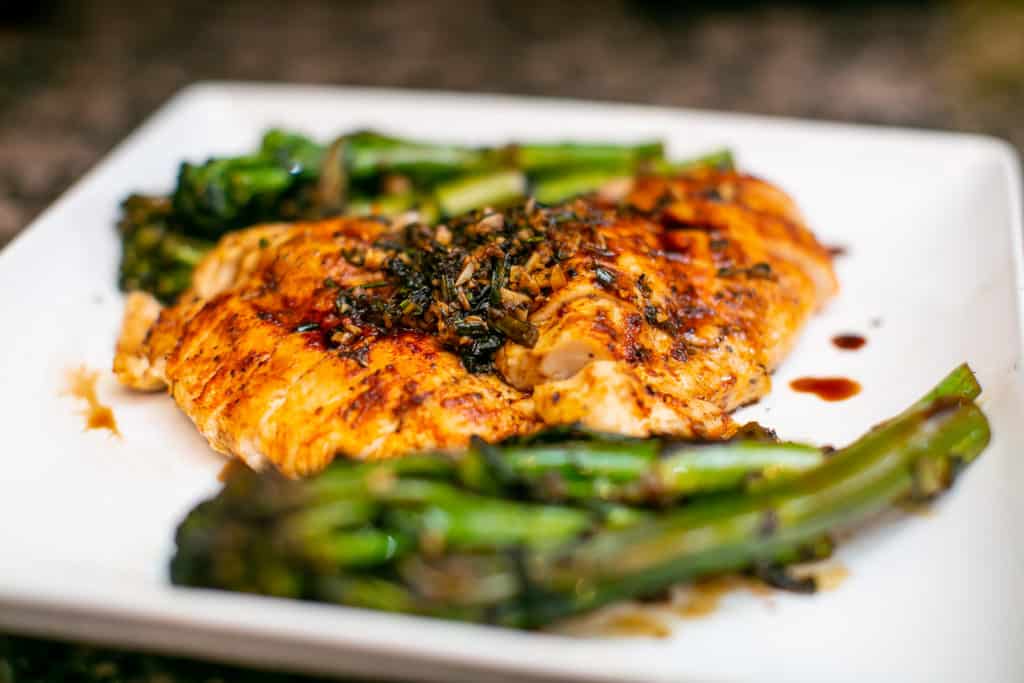 Close up of oven baked chicken breast with asparagus