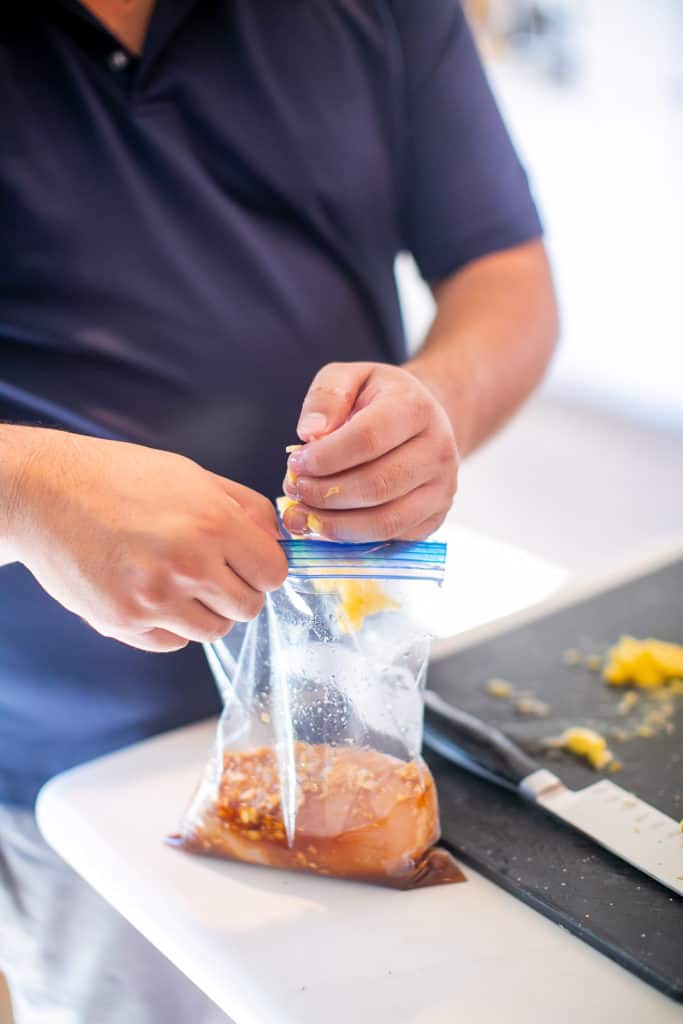 Tossing diced pineapples into the teriyaki marinade