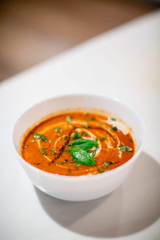 Vibrant red tomato soup with heavy cream and balsamic on top