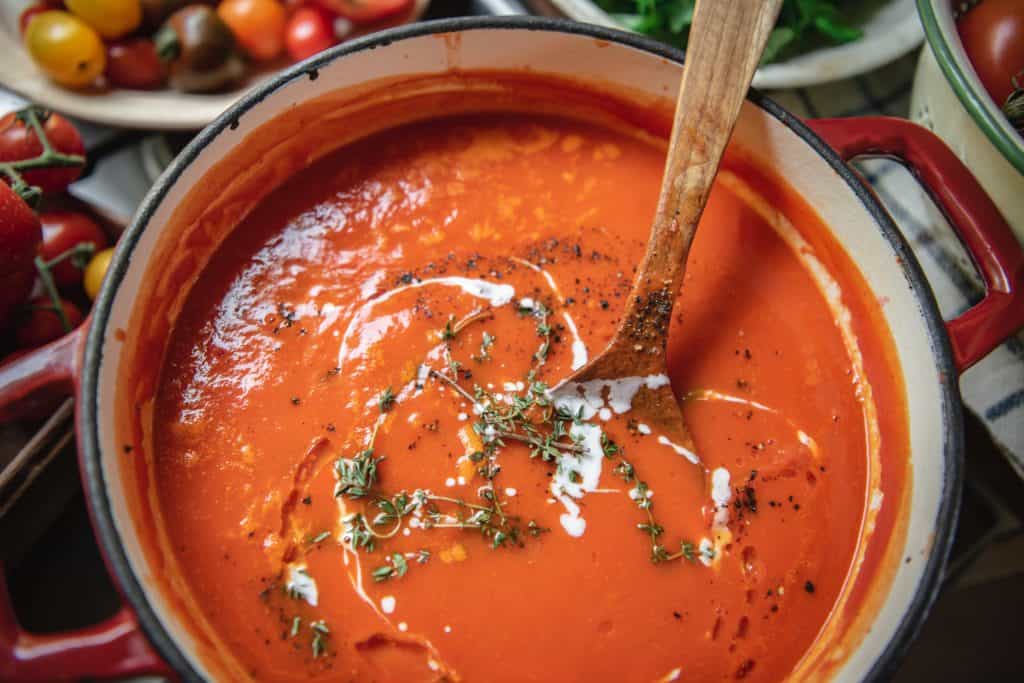 Stirring tomato soup in a pot on the stovetop