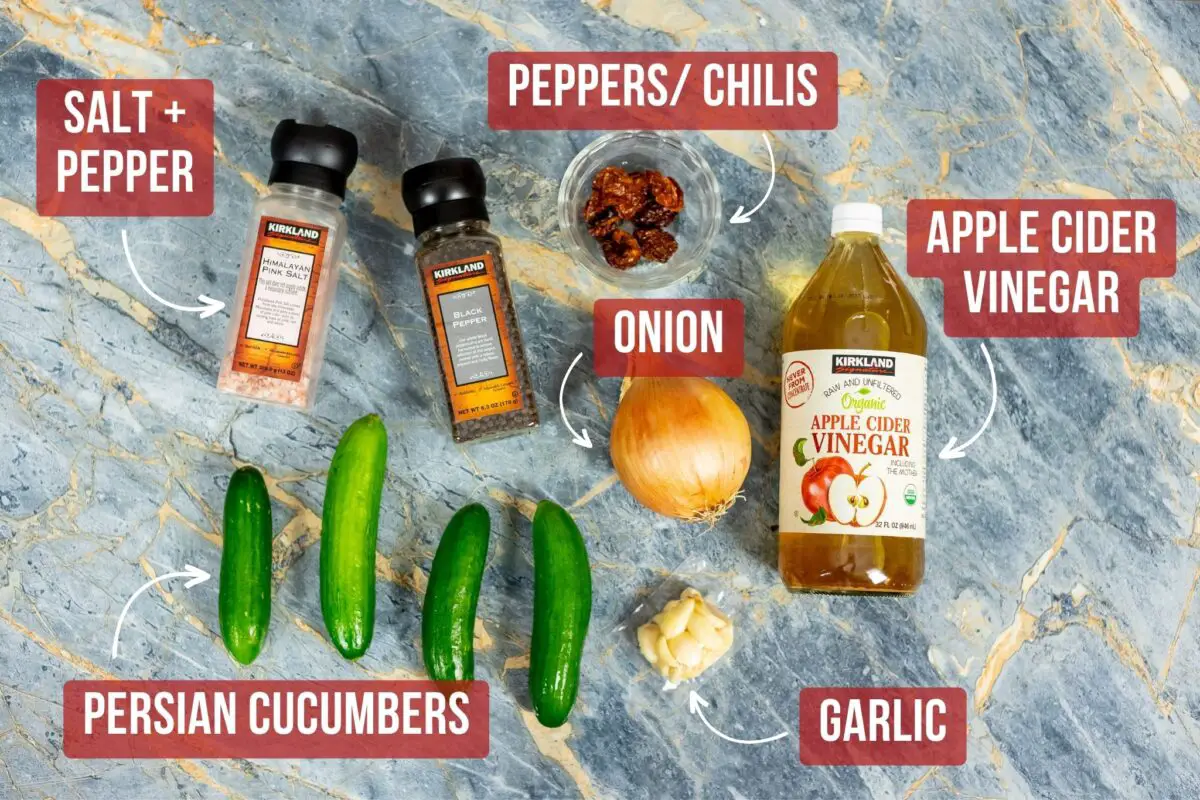 Ingredients laid out on a blue marble table needed to make spicy pickle juice