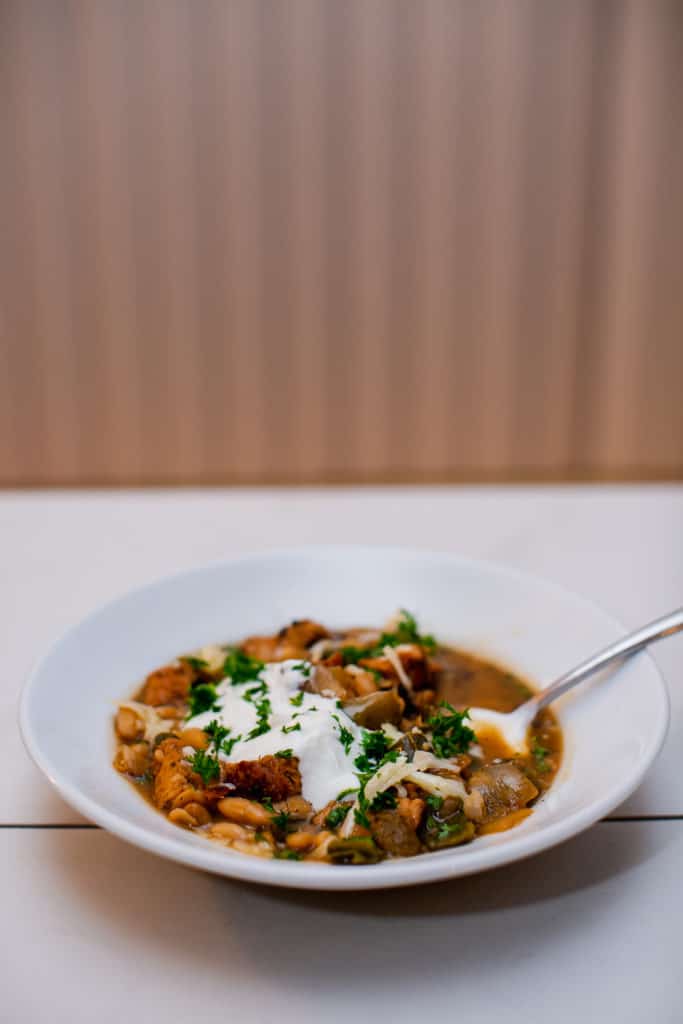 White bean chili topped with melted cheese