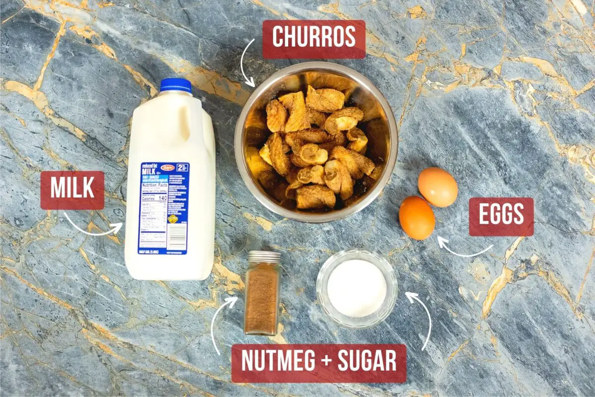 Churro bread pudding ingredients on a blue marble table