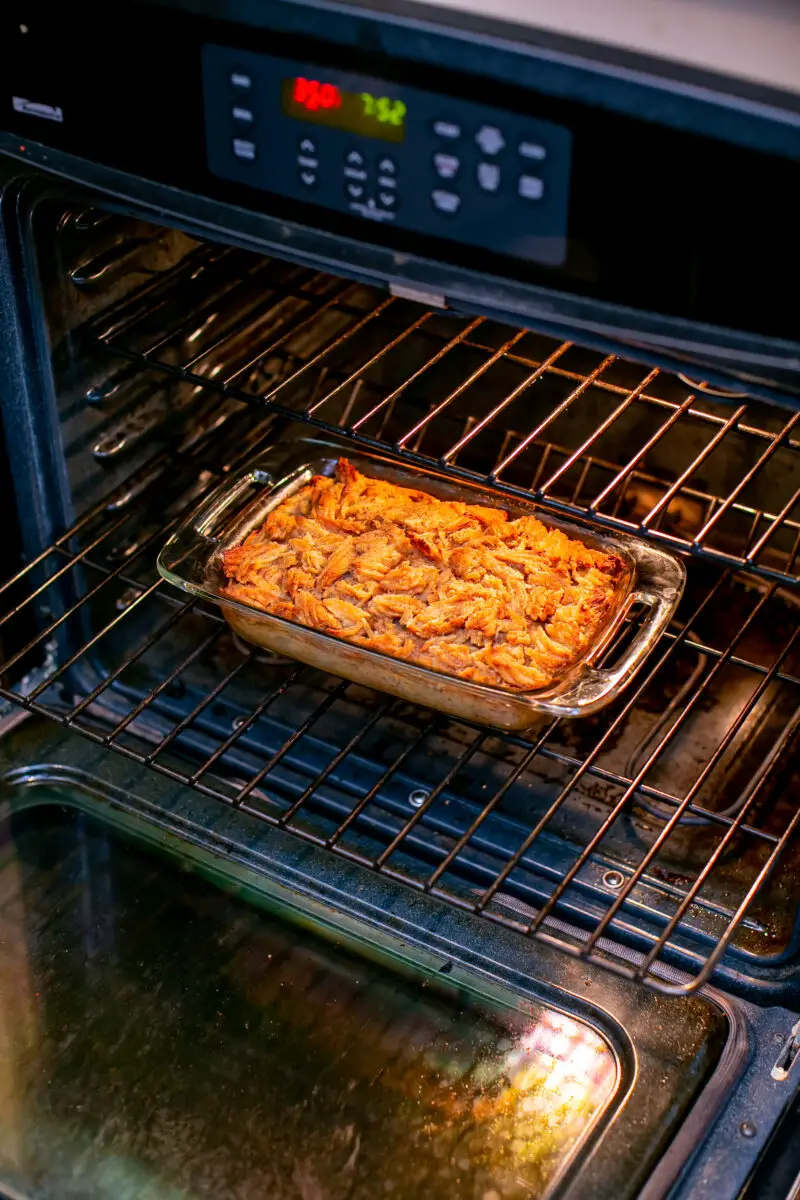 Churro bread pudding placed inside an oven to cook