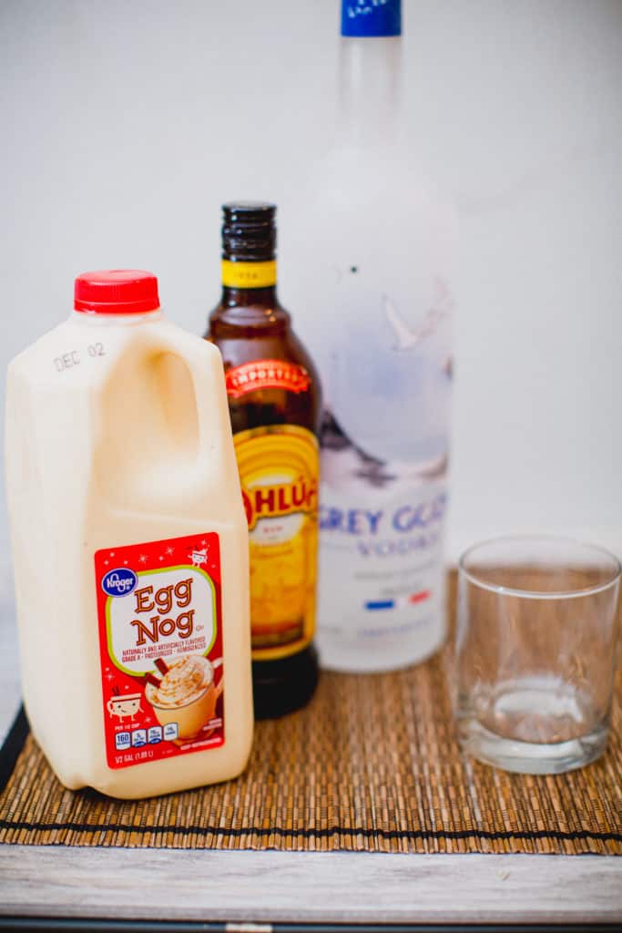 Ingredients for eggnog white Russian cocktail recipe set on a table mat