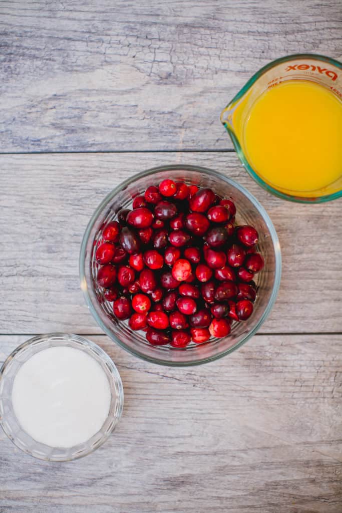 Ingredients for homemade cranberry  sauce prepared on a wooden table