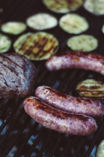 Slightly charred bratwursts after being cooked on a grill