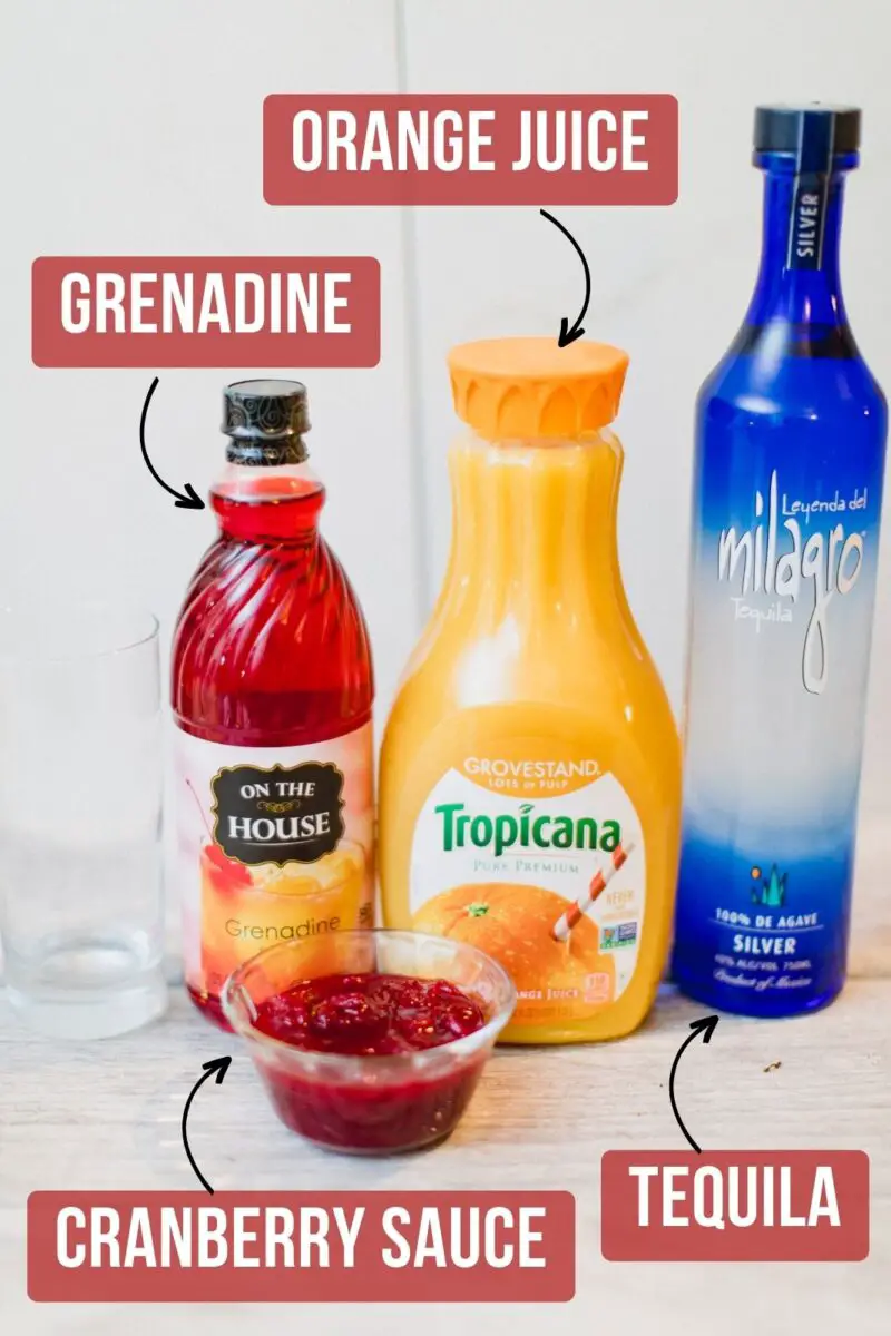 Ingredients needed for a cranberry tequila sunrise cocktail laid out on a table