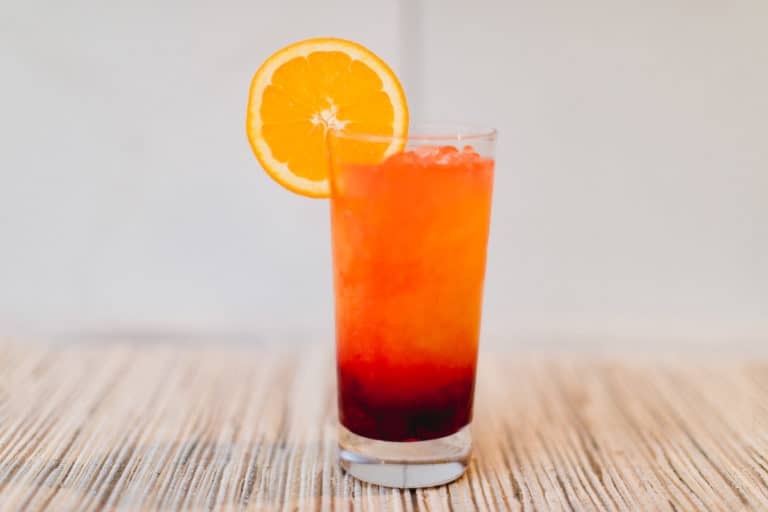A cold glass of cranberry tequila sunrise cocktail