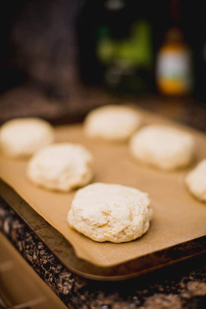 Prepared cheesy biscuit dough lined up in a tray about to go in the oven