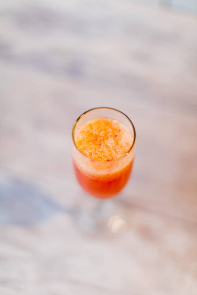 An orange cranberry mimosa with high pulp