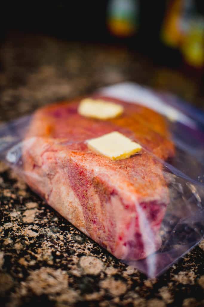 Steak prepared with seasoning and butter while encased in a Ziploc