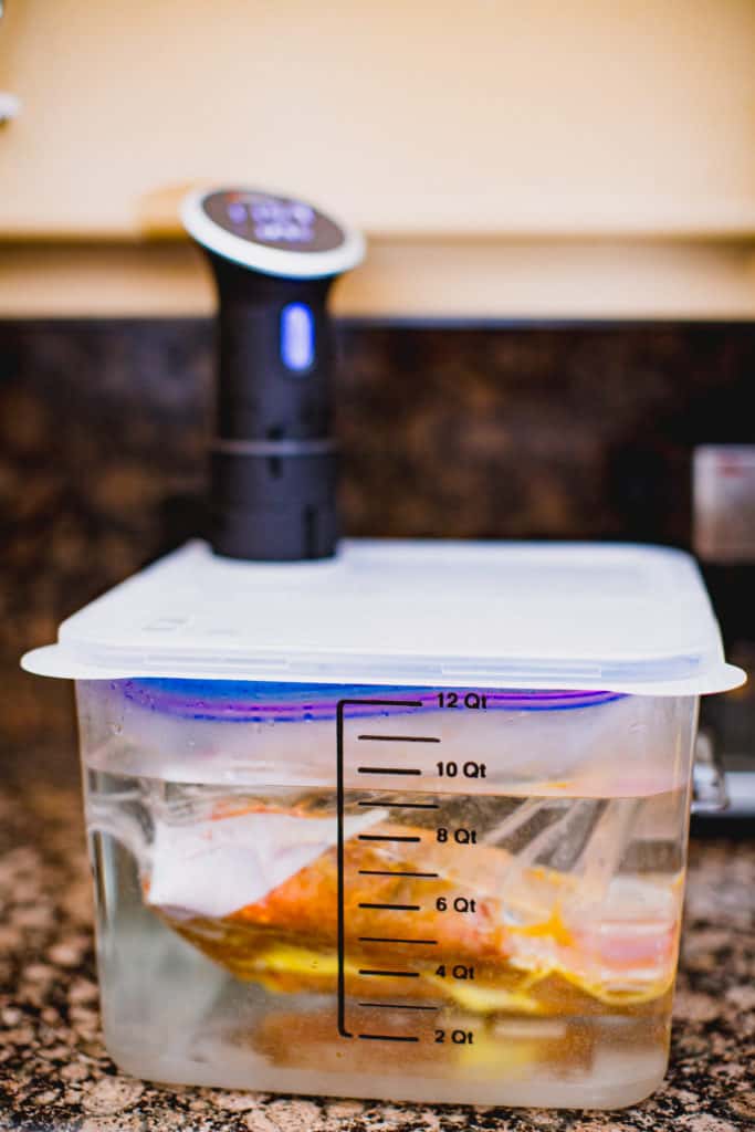 Prepared ribeye steak encased in a Ziploc while being cooked in a sous vide