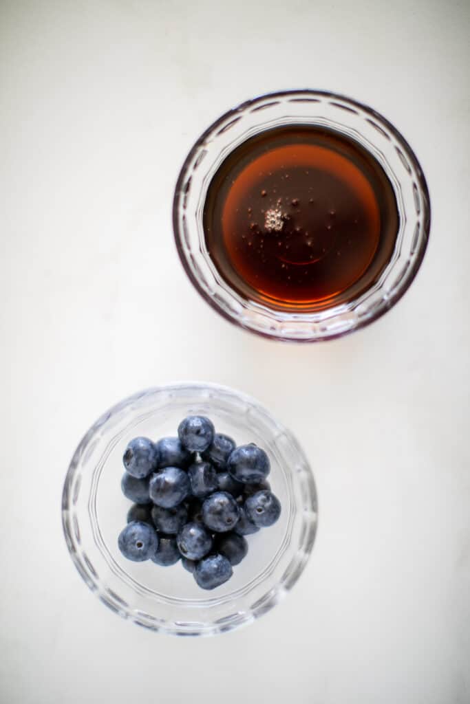 Blueberries and maple syrup in separate bowls