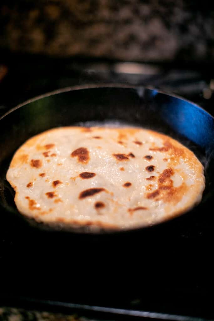 Naan being fried in pan