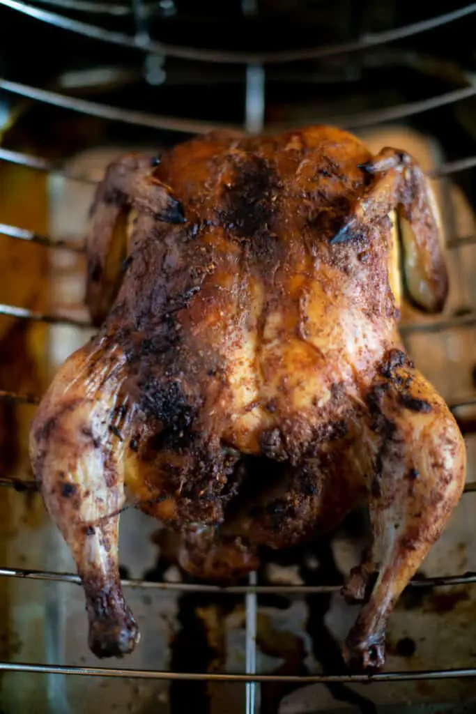 Whole chicken roasting in an oven