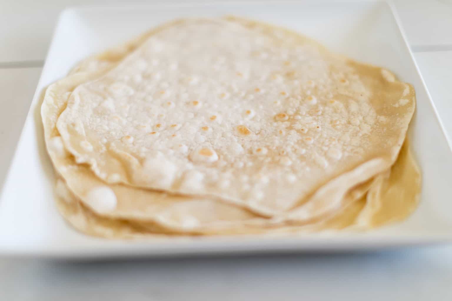 A pile of soft flour tortilla recipe on a plate