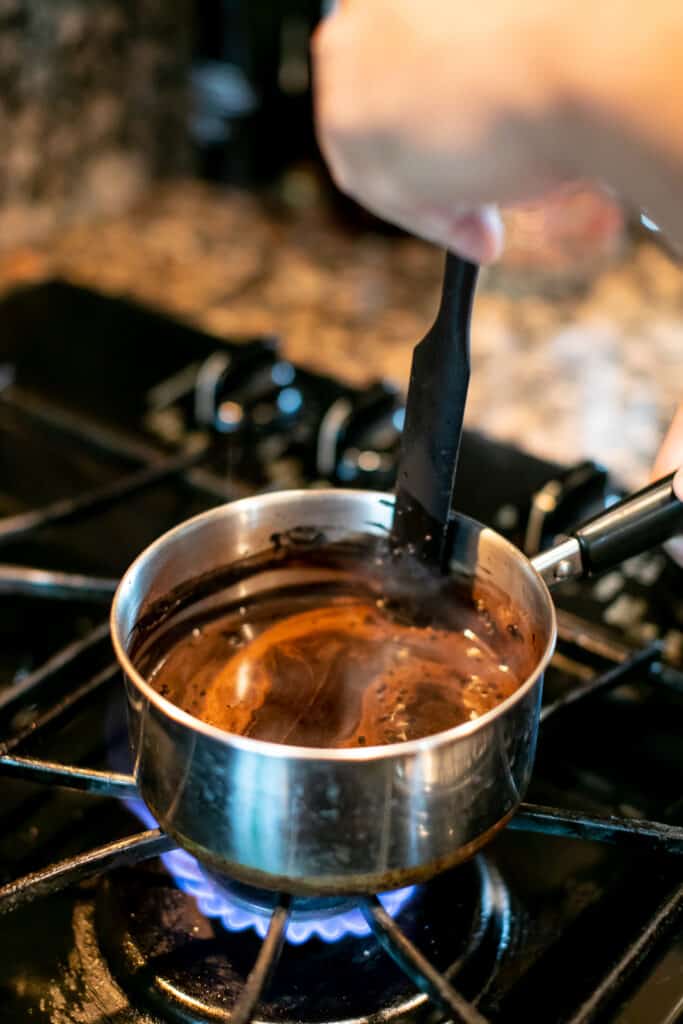 Cocoa powder and sugar mixture cooking in a saucepan