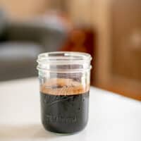 Cocoa powder chocolate sauce in a mason jar placed on a white table