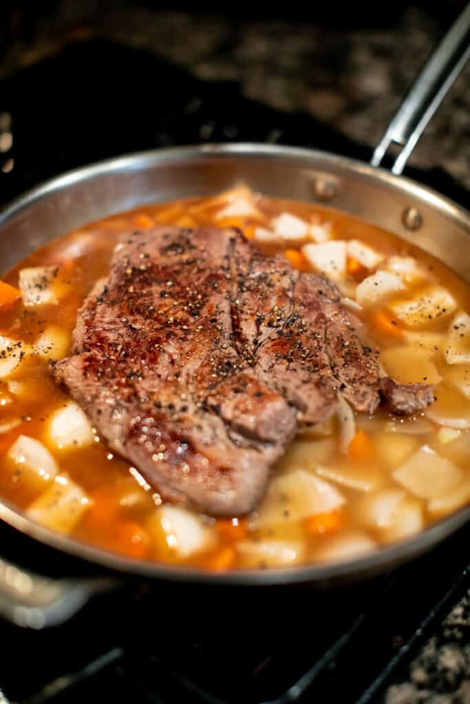 Pot roast cooking in a stovetop