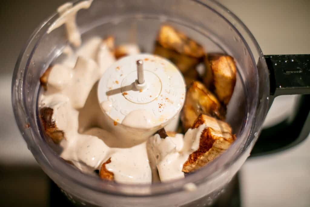 Mixing up all the ingredients for vegan baba ganoush in a food processor