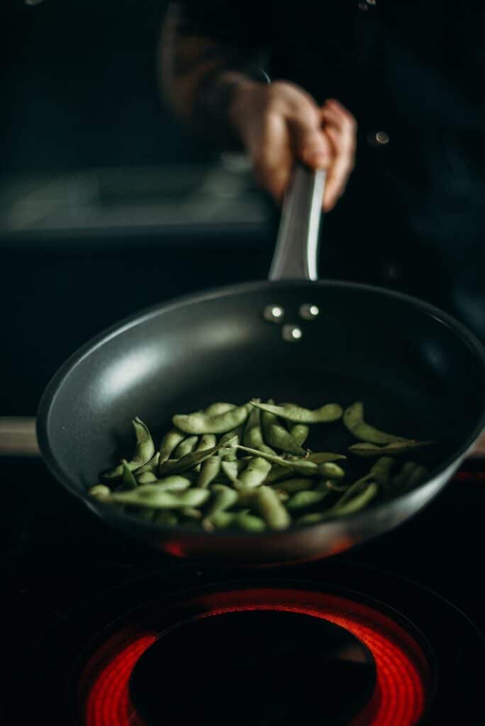 Green beans being cooked in a pan