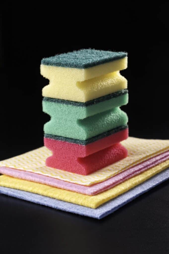 Sponge stacked on top of each other to be used to clean wooden salad bowls