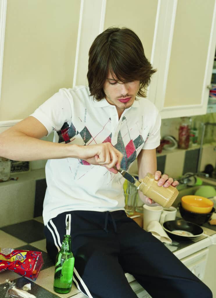 Man trying to clean a peanut butter jar