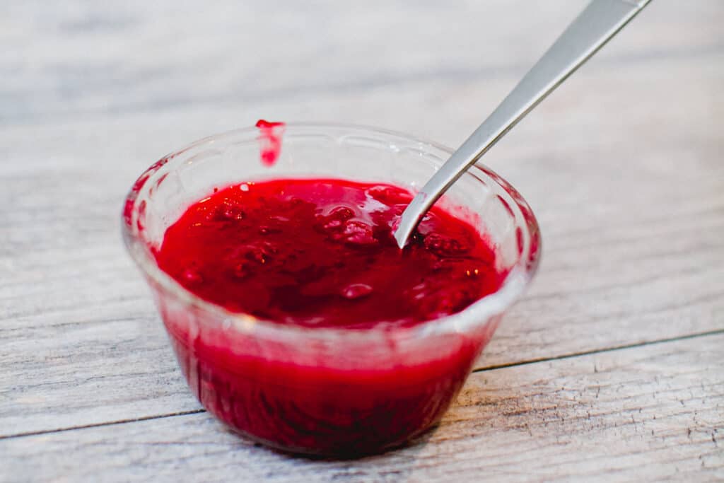 Homemade cranberry sauce on a wooden counter