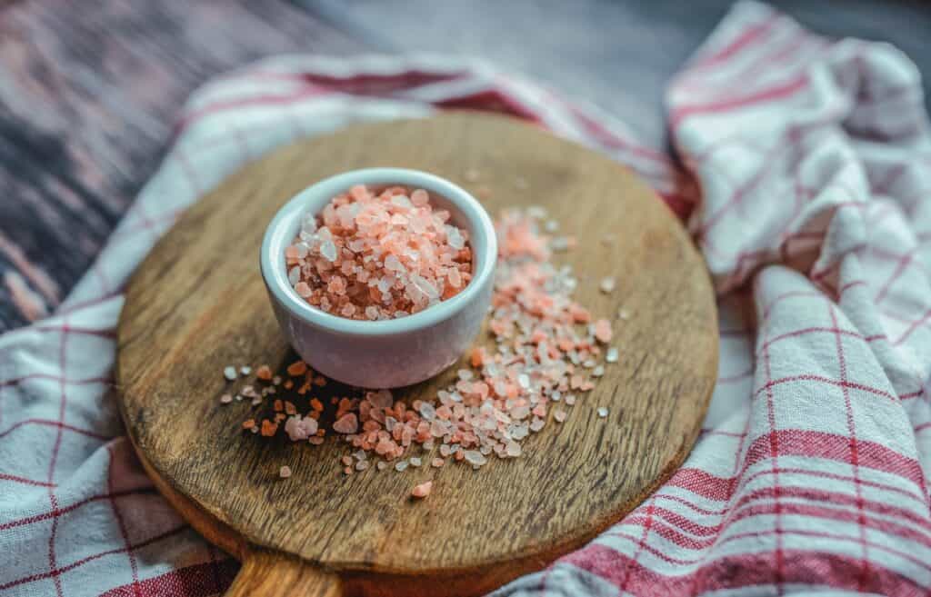 Pink sea salt on a wooden cutting board