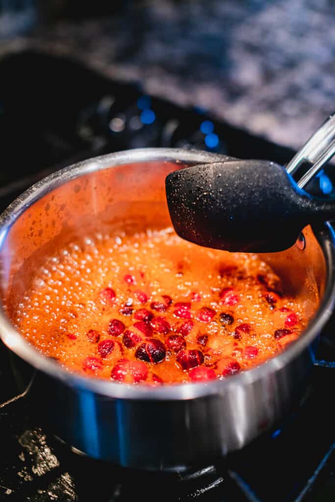 Cranberries boiling in a pot on the stove