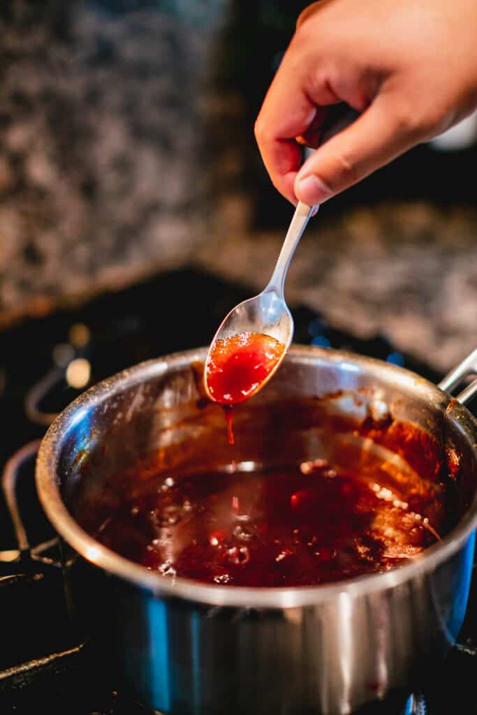 Cranberry barbeque sauce thickening on the stovetop