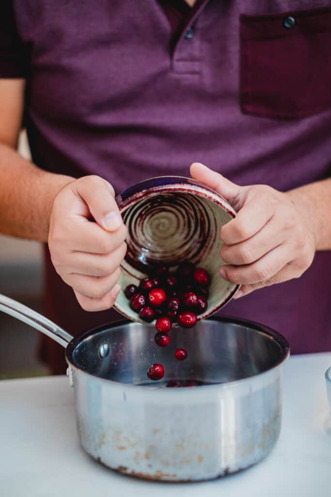 Cranberries being poured into a pot