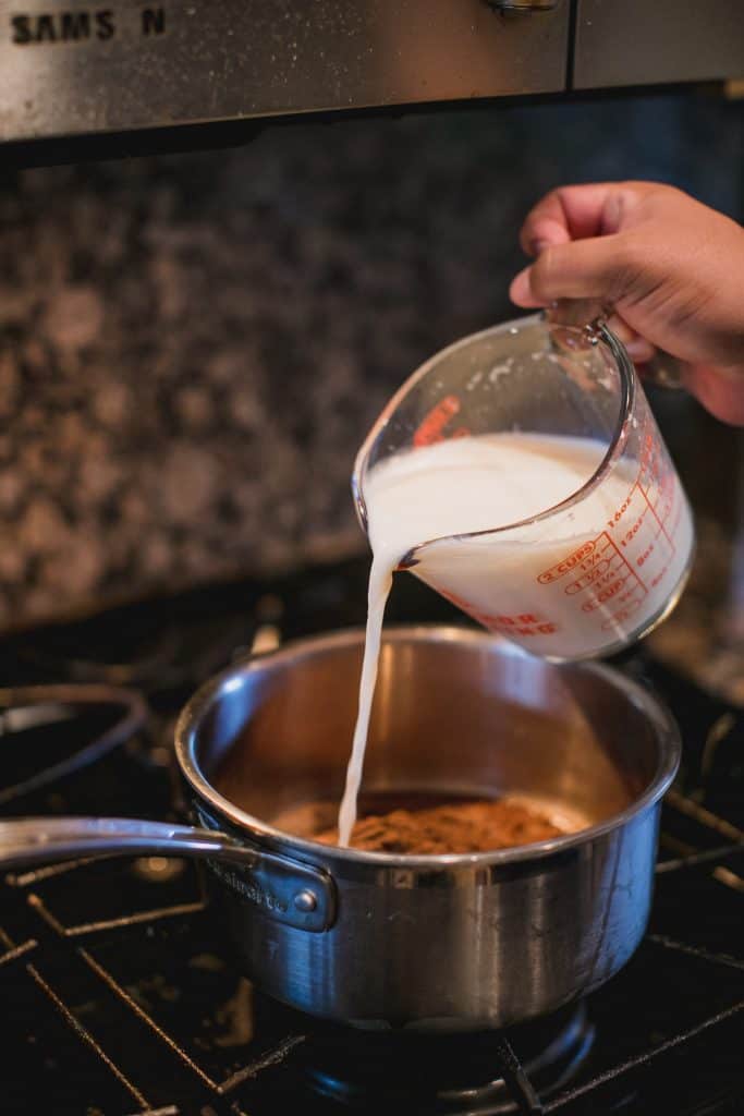 Milk being poured in a saucepan