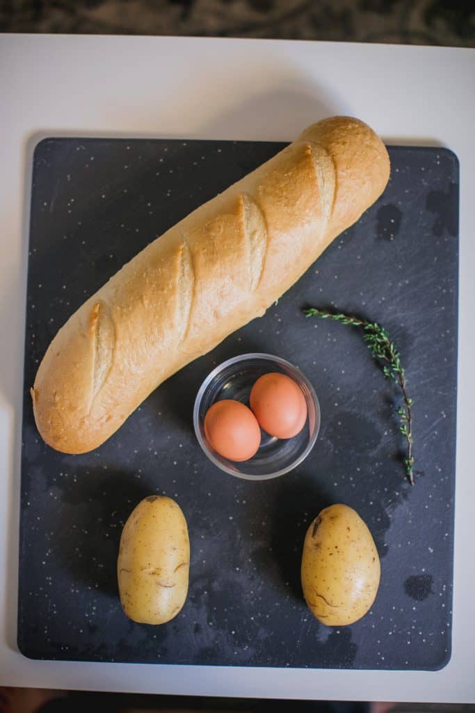 French baguette, eggs and potatoes in a table