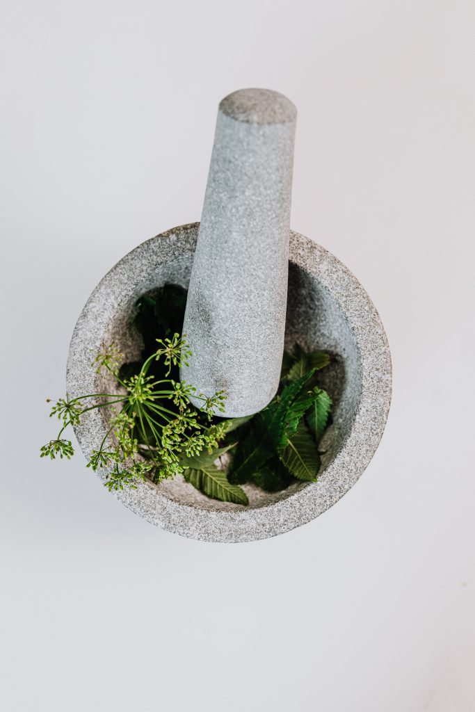 top shot of mortar and pestle with herbs