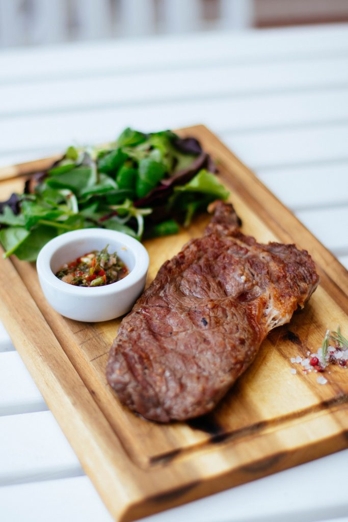 steak and vegetable on wooden plate