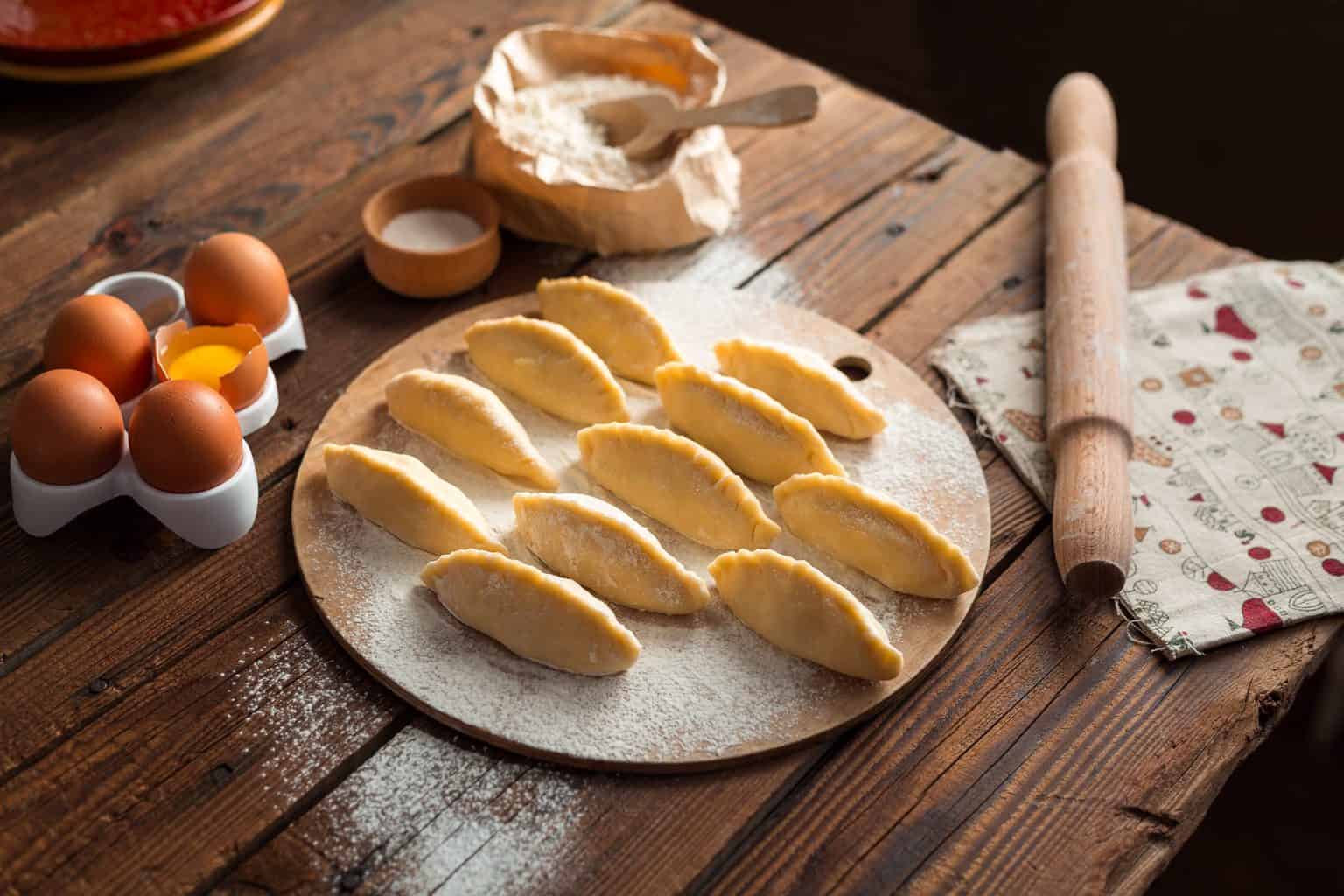 Empanadas being prepared to bake