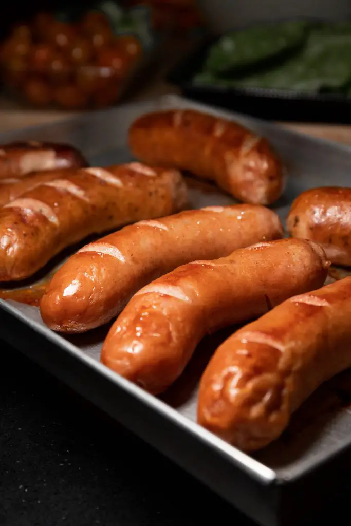 Close up shot of sausages on a pan