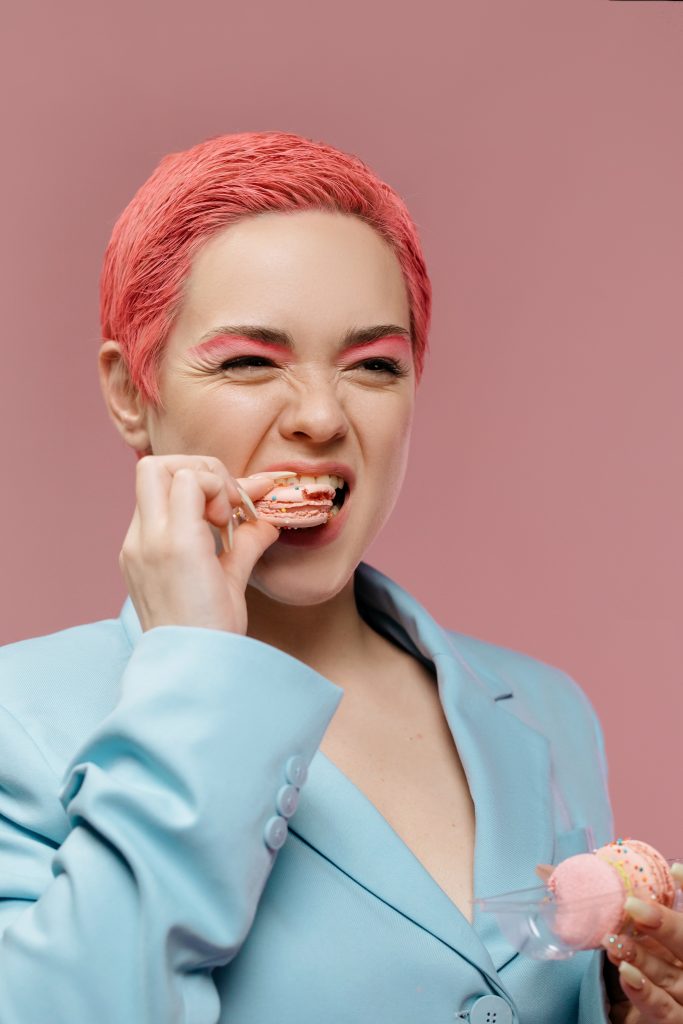 Woman taking a bite off a macaron