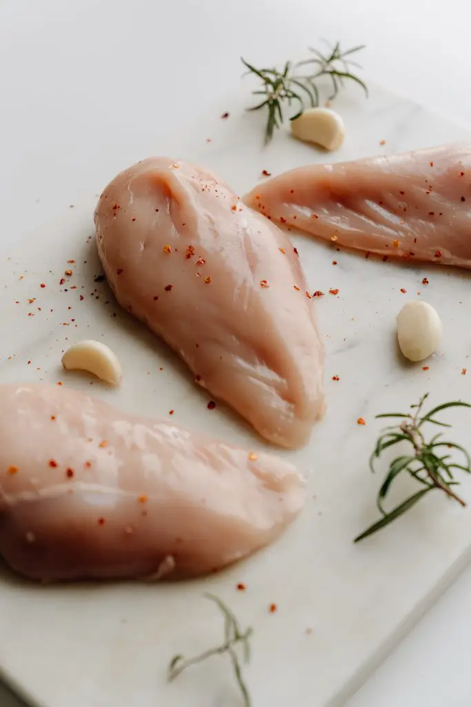 Raw breast chicken pieces with spices