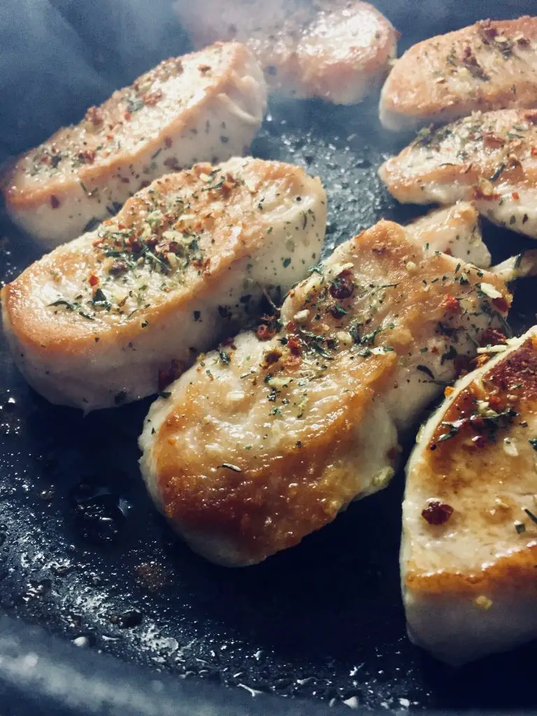 Chicken being grilled inside a pan