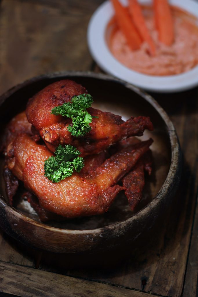 Barbecue flavored chicken wings in a small platter